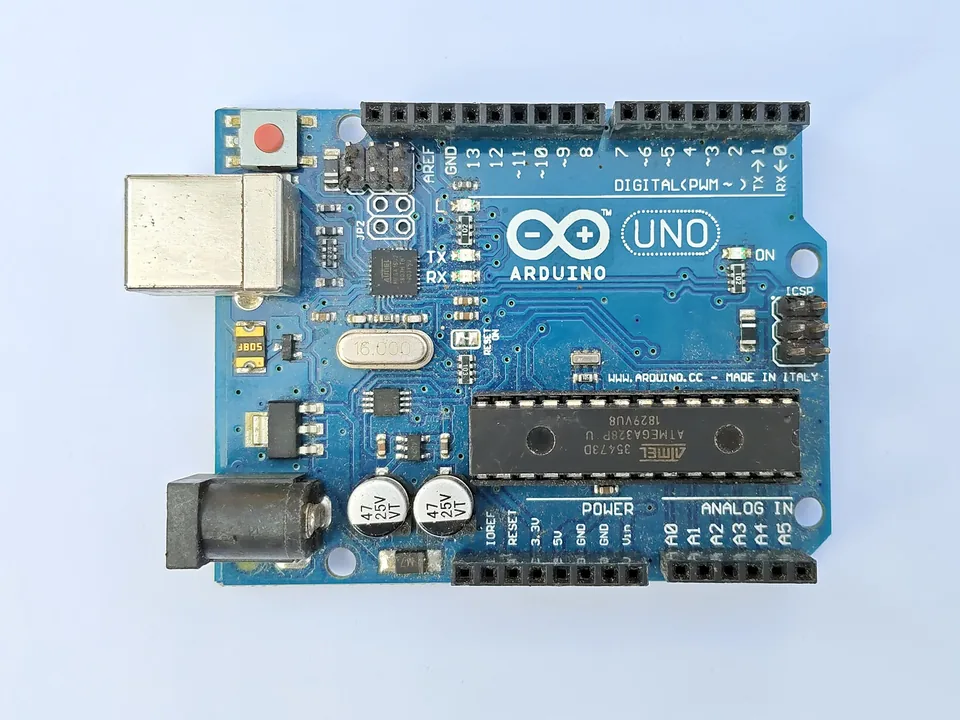Top view of an Arduino Uno R3 board with its USB-B socket, barrel jack and ATmega328P chip