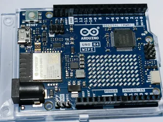 Arduino Uno R4 WiFi board with its 12 by 8 LED matrix, in a clear plastic case